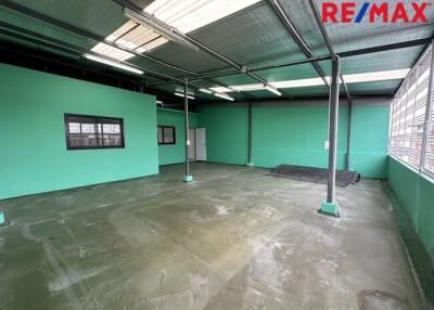 Spacious industrial or commercial space with large windows and high ceilings