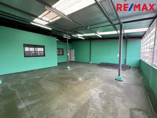 Spacious industrial or commercial space with large windows and high ceilings