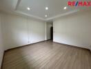 Spacious living area with wooden flooring and ceiling lights