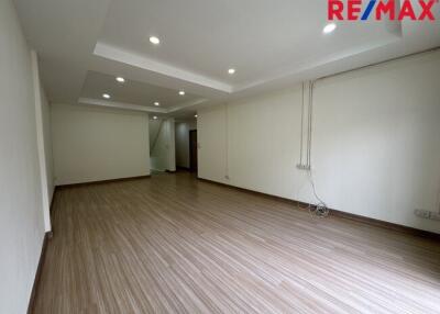 Spacious unfurnished living area with wooden flooring and recessed lighting