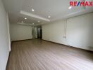 Spacious unfurnished living area with wooden flooring and recessed lighting