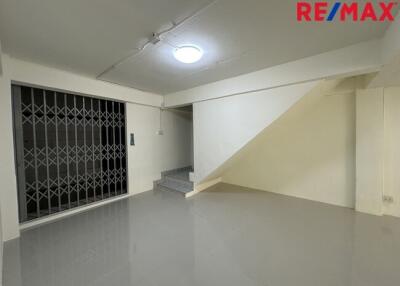 Ground floor living area with stairs and metal gate