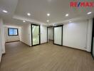 Spacious main living area with wooden flooring and large windows