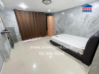 Bedroom with double bed, wooden wardrobe, and large brown curtains