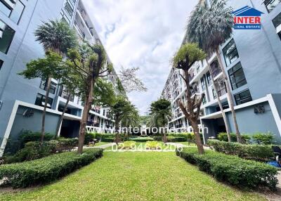 Exterior view of the apartment complex with landscaped garden