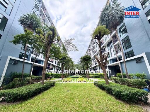 Exterior view of the apartment complex with landscaped garden