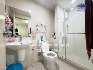 Modern bathroom with shower, sink, and toilet