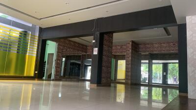 Modern interior space with large windows and exposed brick walls