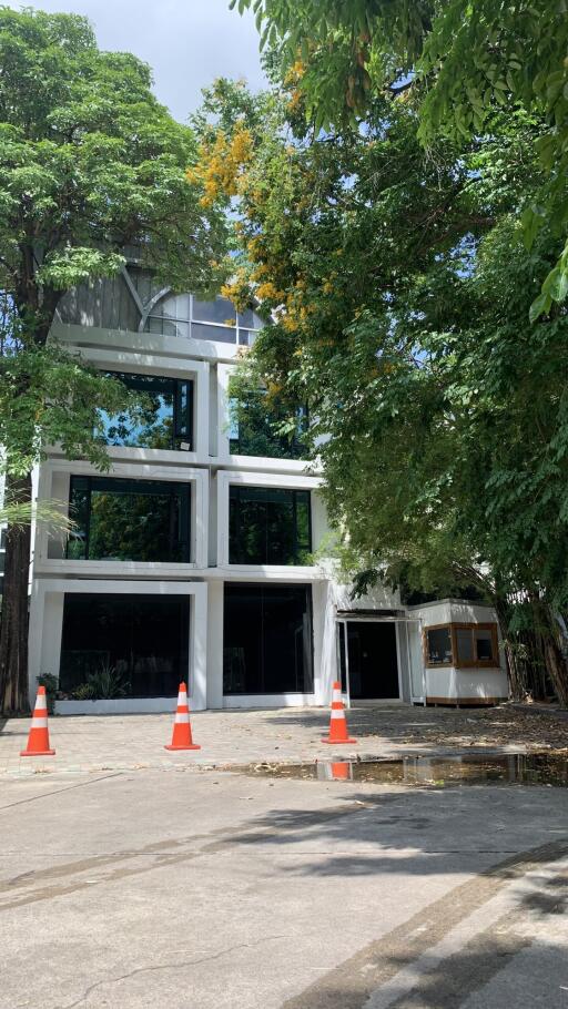 Modern multi-story building surrounded by trees