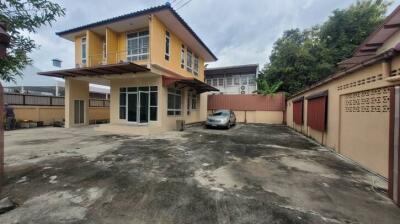 Exterior view of a two-story house with driveway and car