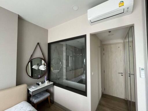 Modern bedroom with a vanity area, air conditioning, and en-suite bathroom