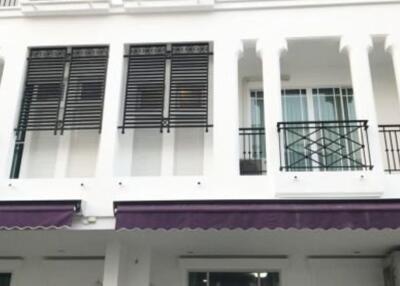 Exterior view of the white building facade with balconies and modern railings