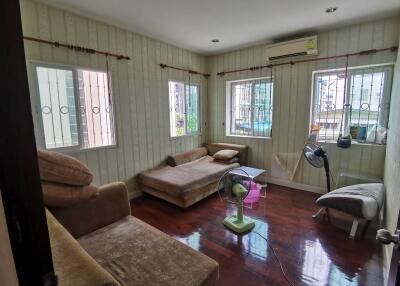 Cozy living room with multiple seating options and wooden flooring