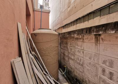 Outdoor area with water tank and construction materials