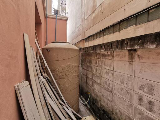 Outdoor area with water tank and construction materials