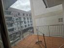 Outdoor balcony space with a partial view of surrounding buildings