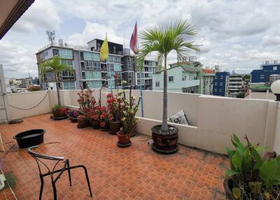 Spacious balcony with potted plants and city view