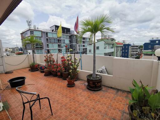 Spacious balcony with potted plants and city view