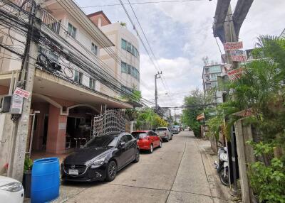 Street view with cars parked and residential buildings