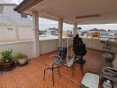 Spacious balcony with city views and tiled flooring.