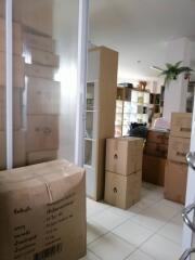 Room with packed boxes and storage shelves