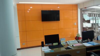 Office with modern orange wall paneling and workstations