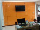 Office with modern orange wall paneling and workstations