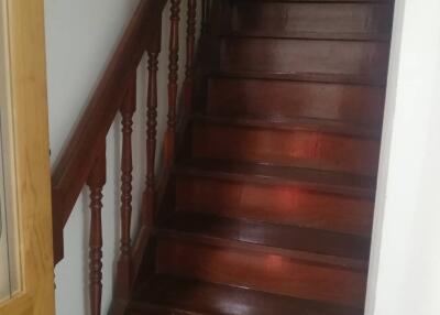 A wooden staircase with handrail
