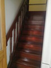A wooden staircase with handrail