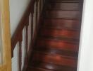 A wooden staircase with handrail