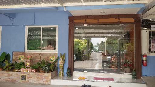 Front entrance of a building with plants and glass door