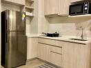 Modern kitchen with stainless steel refrigerator, microwave, and ample cabinetry