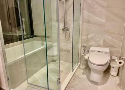 Modern bathroom with glass shower enclosure and bathtub