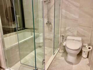 Modern bathroom with glass shower enclosure and bathtub