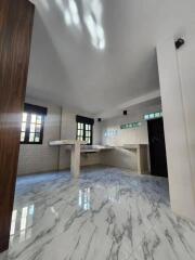 Bright kitchen with marble flooring and counter spaces