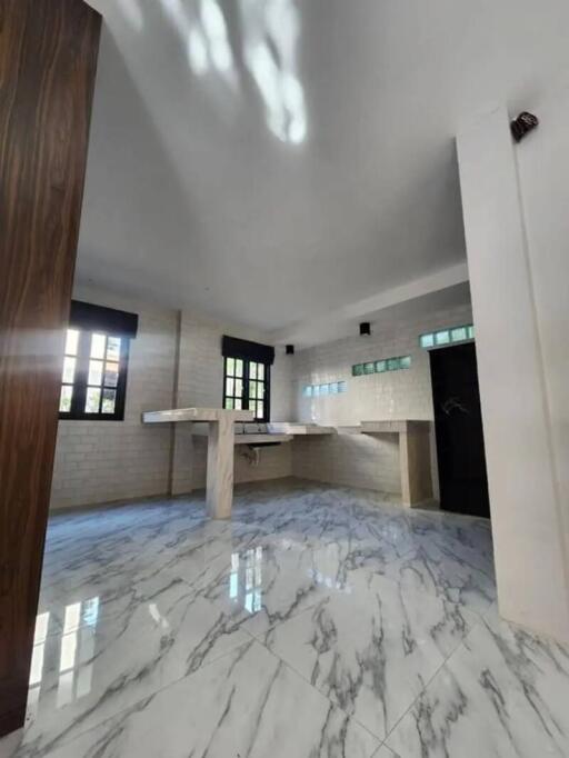 Bright kitchen with marble flooring and counter spaces