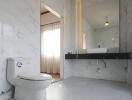 Modern bathroom with white marble tiles and floating vanity