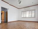 Spacious living room with hardwood floor and large window