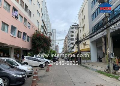 Street view of apartment buildings and parked cars