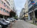 Street view of apartment buildings and parked cars