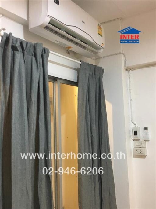 Room with split air conditioner and gray curtains