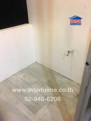 Empty bathroom space with incomplete wall and floor tiling