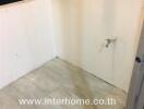 Empty bathroom space with incomplete wall and floor tiling