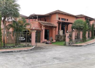 Exterior view of a large house with tropical landscaping