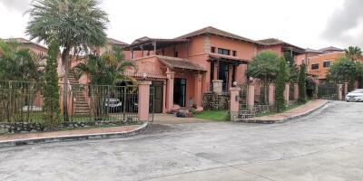 Exterior view of a large house with tropical landscaping