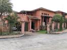 Exterior view of a large house with tropical landscaping