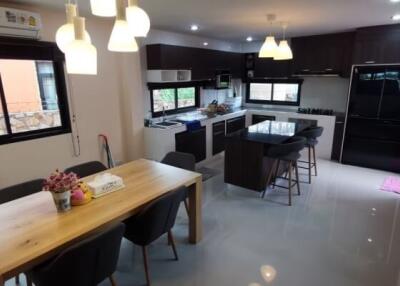 Modern kitchen with dining table and appliances