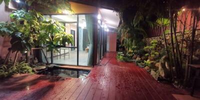 Patio with wooden decking and large glass doors leading to interior