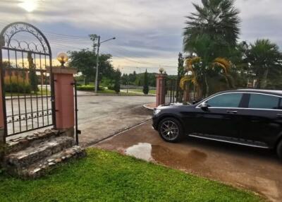 Driveway with a parked car and gate