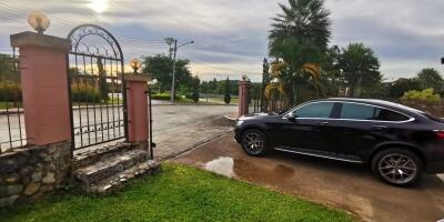 Driveway with a parked car and gate